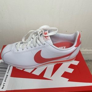 Coral and white Nike cortez